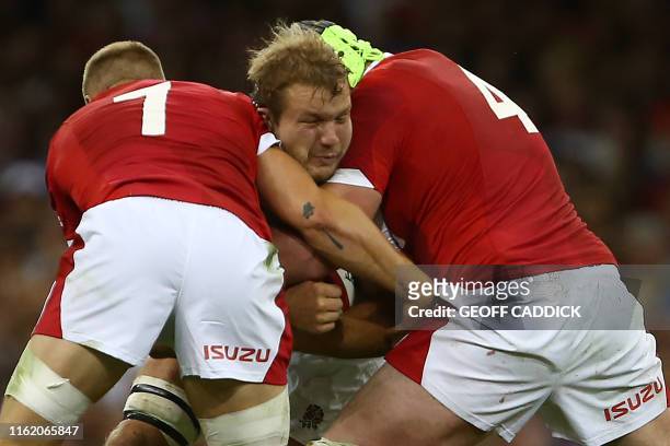 England's lock Joe Launchbury is tackled by Wales' flanker James Davies and Wales' lock Jake Ball during the international Test rugby union match...