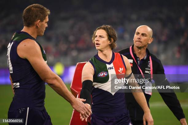 Nat Fyfe and Aaron Sandilands of the Dockers chat at warmup during the 2019 AFL round 22 match between the Fremantle Dockers and the Essendon Bombers...