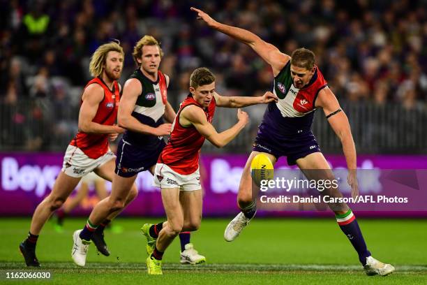 Aaron Sandilands of the Dockers chases down a loose ball against Brayden Ham of the Bombers during the 2019 AFL round 22 match between the Fremantle...