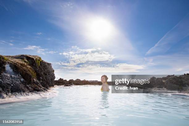 portrait of smiling asian young woman in hot spring - blue lagoon iceland stock-fotos und bilder