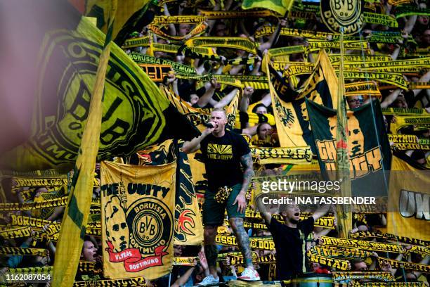 Dortmund's supporters celebrate the 5-1 victory over Augsburg after the German first division Bundesliga football match BVB Borussia Dortmund v...