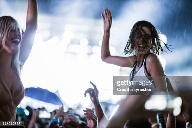 dancing on music festival during rainy night! - dancing in the rain stock pictures, royalty-free photos & images