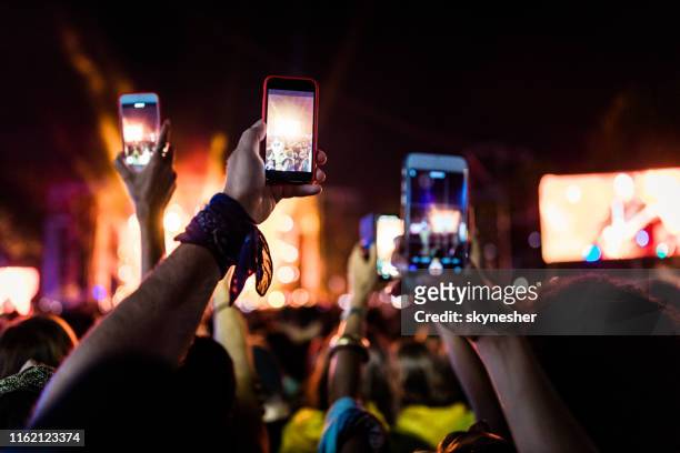 making a music festival video via mobile phone! - show recording stock pictures, royalty-free photos & images