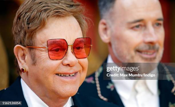 Elton John and David Furnish attend "The Lion King" European Premiere at Leicester Square on July 14, 2019 in London, England.