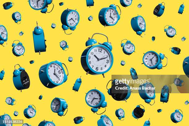full frame shot of alarm clocks on yellow background - large group of objects stock pictures, royalty-free photos & images