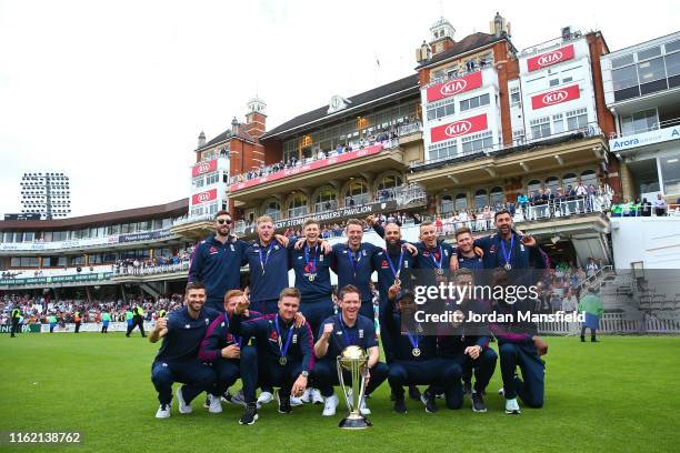 Eoin Morgan of England parades the trophy with young fans during the England ICC World Cup Victory Celebration at The Kia Oval on July 15, 2019 in...