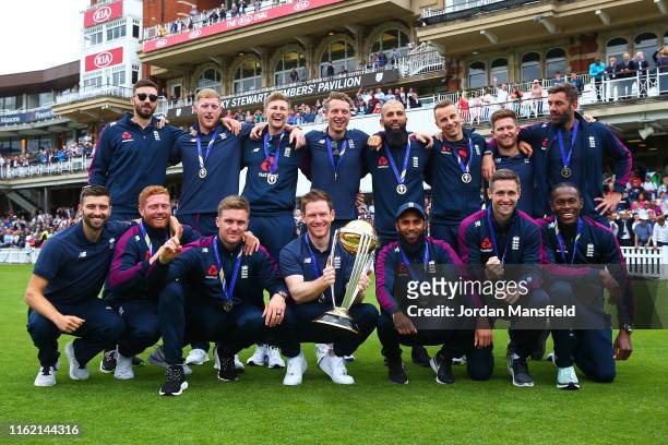Eoin Morgan of England parades the trophy with young fans during the England ICC World Cup Victory Celebration at The Kia Oval on July 15, 2019 in...