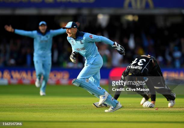 Jos Buttler of England celebrates running out Martin Guptill of New Zealand to seal victory for England during the Final of the ICC Cricket World Cup...