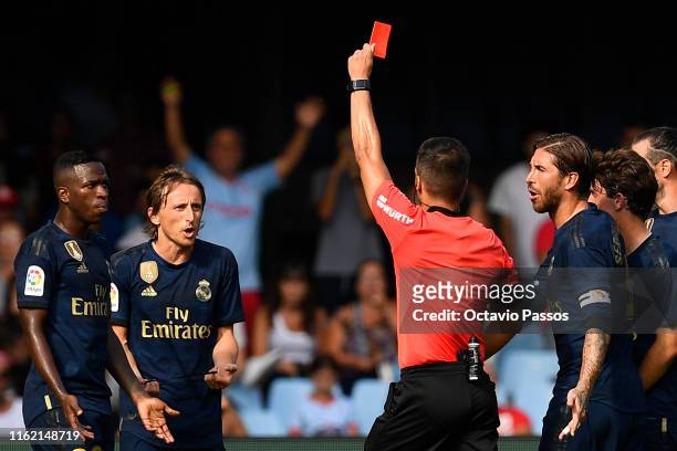 Estrada Fernandez, the referee, shows a red card to Luka Modric of Real Madrid during the Liga match between RC Celta de Vigo and Real Madrid CF at...