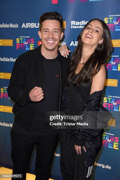 Nico Santos and Lena Meyer-Landrut attend the 'Stars for free' music festival at Barclaycard Arena on August 17, 2019 in Hamburg, Germany.