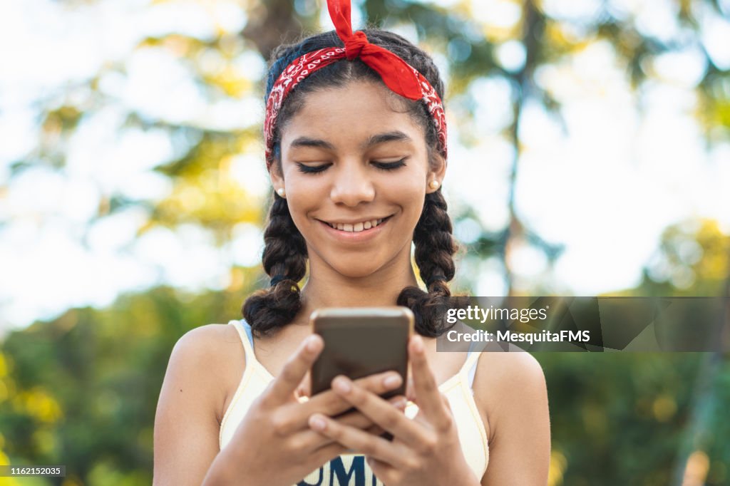 Teenager texting a message on smart phone