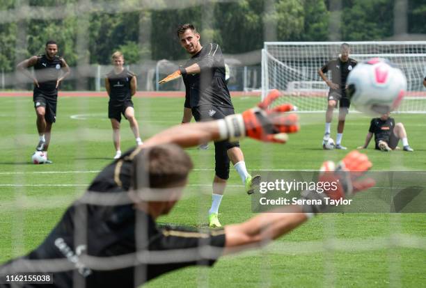 Newcastle United Goalkeeper Martin Dubravka takes a penalty whilst teammate Freddie Woodman dives in an attempt to make a save during the Newcastle...