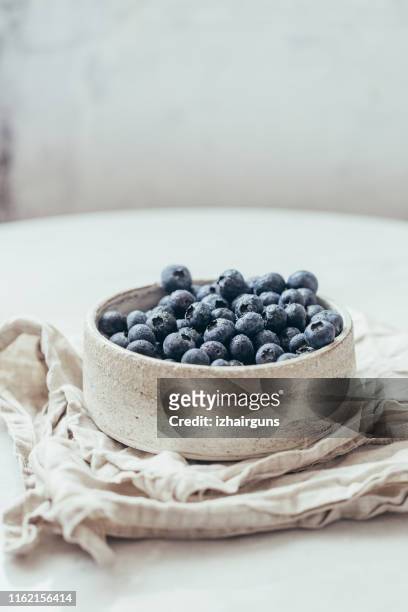 blueberry bowl on white background with copy space in rustic style - blueberries in bowl stock pictures, royalty-free photos & images