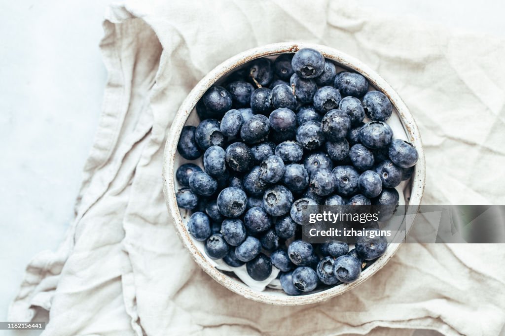 Blueberry bowl on white background with copy space in rustic style