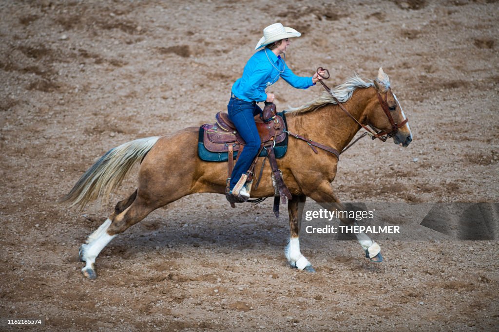 Cowgirl Rodeo Goat Tying event on horse