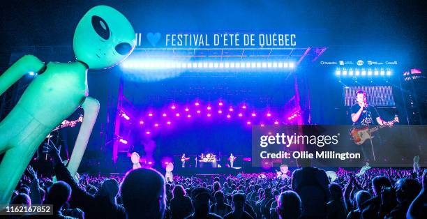 Mark Hoppus, Travis Barker and Matt Skiba of Blink 182 perform headlining the final day, Day 11 of the 52nd Festival D'été Quebec on the Bell Stage...