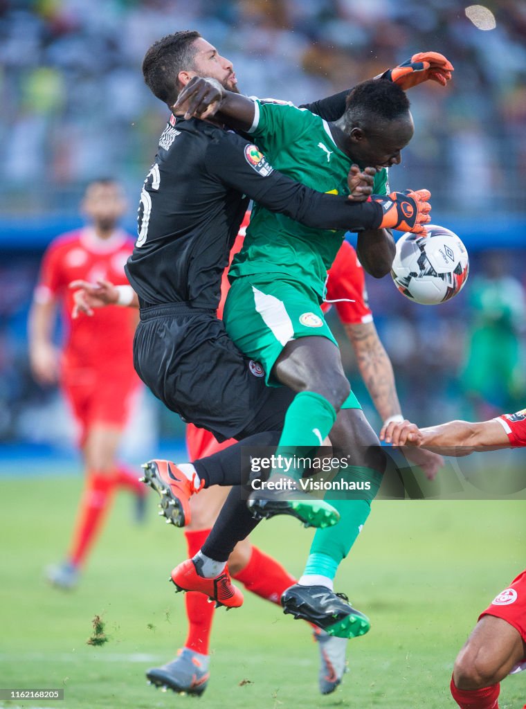 Sadio Mané of Senegal clashes with goalkeeper Hassen Mouez of Tunisia ...