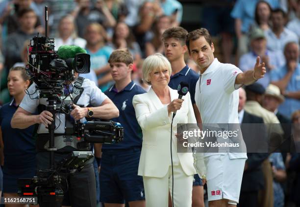 Presenter Sue Barker interviews Roger Federer of Switzerland after his defeat to Novak Djokovic of Serbia in the Final of the Gentlemen's Singles on...