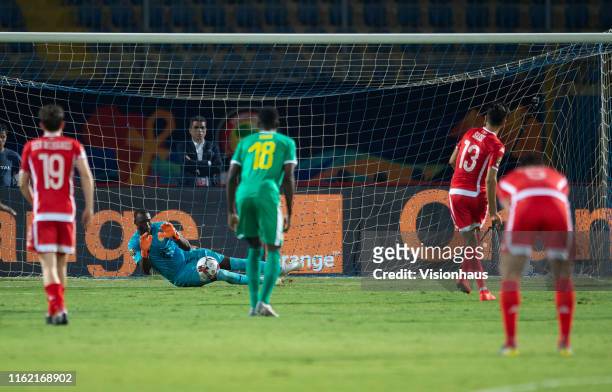 Ferjani Sassi of Tunisia sees his penalty saved by Alfred Gomis of Senegal during the 2019 Africa Cup of Nations Semi Final match between Senegal and...