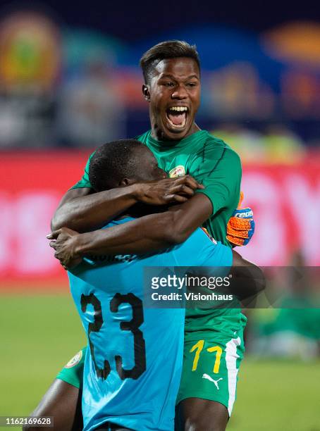 Goalkeeper Alfred Gomis celebrates victory for Senegal with Keita Balde after winning the 2019 Africa Cup of Nations Semi Final match between Senegal...