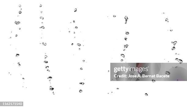 group of drops on line suspended in the air, falling down on a water surface that forms figures and abstract forms, on a white background. - wasser blasen stock-fotos und bilder