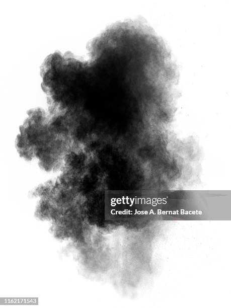 explosion by an impact of a cloud of particles of powder and smoke of color black on a white background. - black smoke stock pictures, royalty-free photos & images