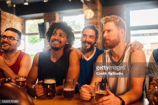 friends watching game - crowd cheering bar stock pictures, royalty-free photos & images