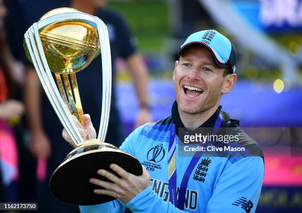Eoin Morgan of England celebrates with his team as he lifts the Cricket World Cup trophy after the Final of the ICC Cricket World Cup 2019 between...