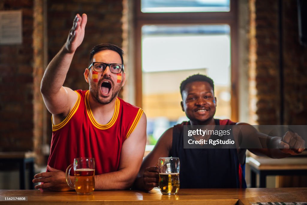 Men shouting when watching a game