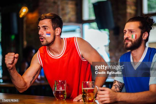 friends cheering for their basketball teams - serbian flag stock pictures, royalty-free photos & images
