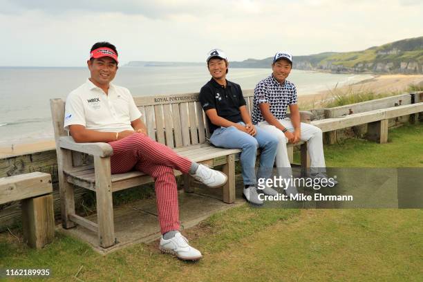 Yuta Ikeda of Japan, Yosuke Asaji of Japan and Yuki Inamori of Japan sit on a bench during a practice round prior to the 148th Open Championship held...