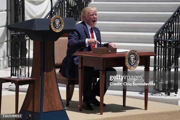 President Donald Trump signs an executive order during his 'Made In America' product showcase at the White House July 15, 2019 in Washington, DC....