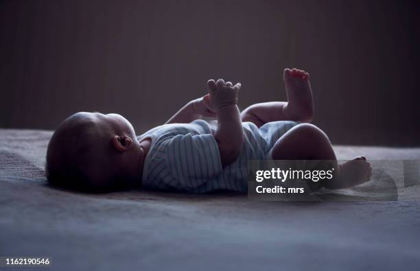 newborn baby - dark baby stock pictures, royalty-free photos & images