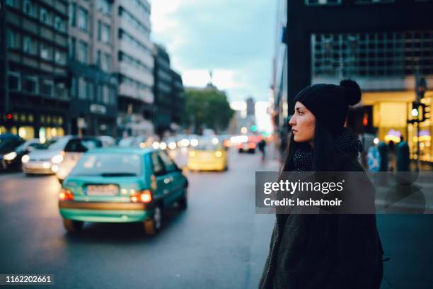 young commuter woman in berlin mitte - low key imagens e fotografias de stock