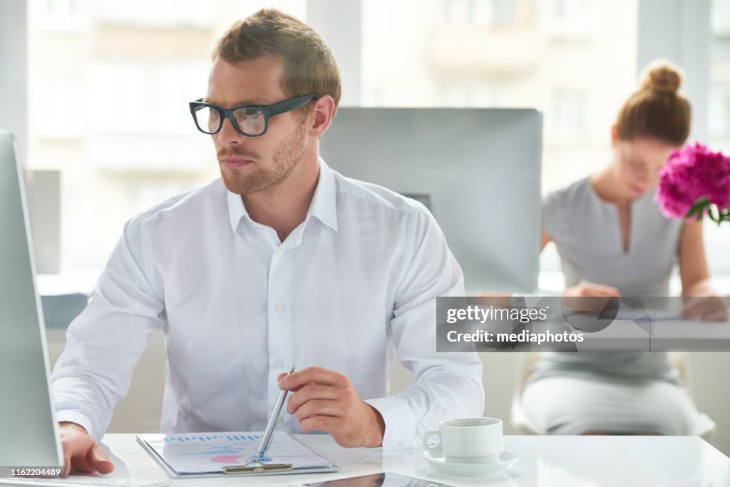 Man Watching Computer Concentrated Man Watching Computer In Office High-Res Stock Photo ...