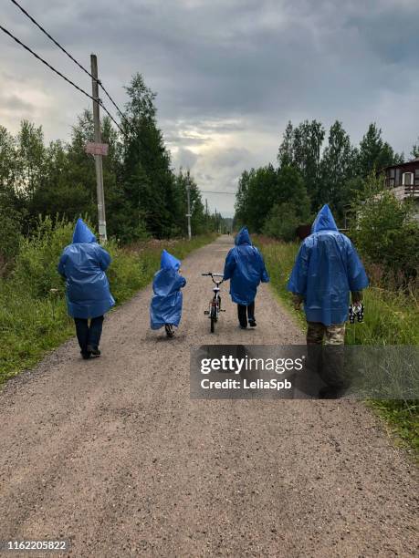 people in blue raincoats - rain cape stock-fotos und bilder