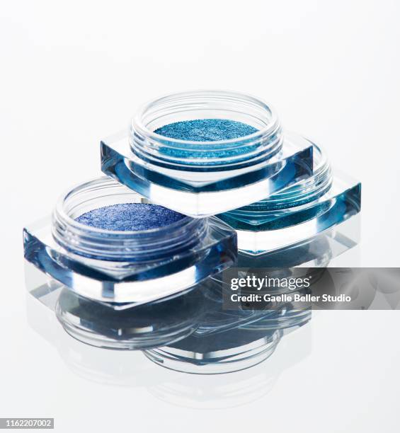 stacked containers of blue shaded eyeshadows - blå ögonskugga bildbanksfoton och bilder