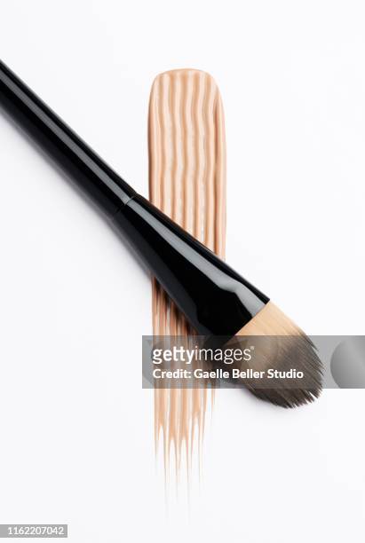 make-up brush and textured stroke of color - concealer stock pictures, royalty-free photos & images