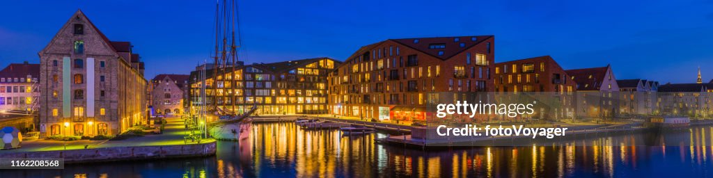 Waterfront apartments illuminated at dusk Copenhagen harbour panorama Denmark