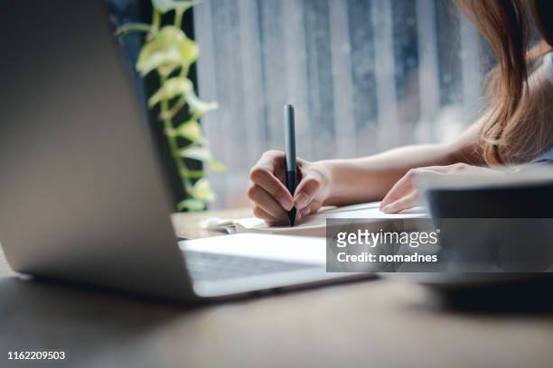 hand holding pen and writing on paper.listing on paper concept. - schreiben stock-fotos und bilder