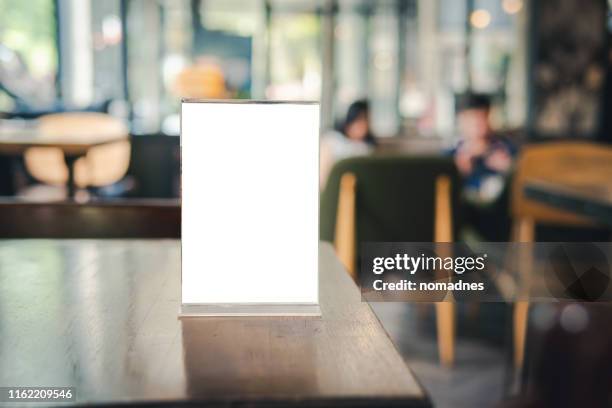 menu card holder with white sheet of paper on table in cafe.card display promotion and information for customer,picture stand,sign holder and photo frame template. - white paper template imagens e fotografias de stock
