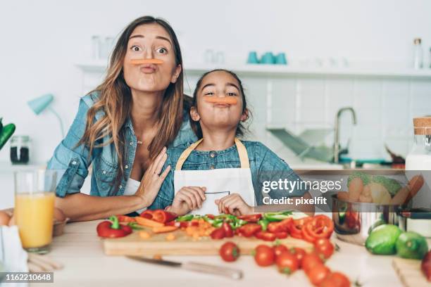 mother and daughter with carrot mustaches - woman playing squash stock pictures, royalty-free photos & images