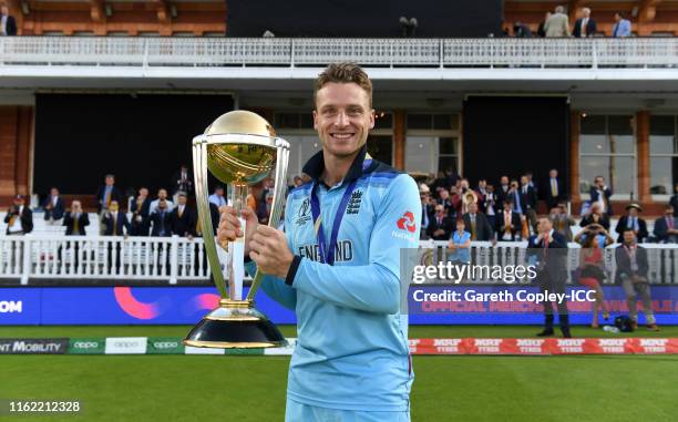 Jos Buttler of England celebrates with the trophy after winning the Final of the ICC Cricket World Cup 2019 between New Zealand and England at Lord's...