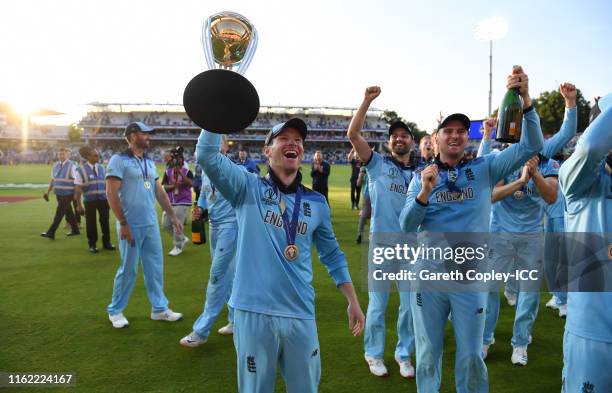 England captain Eoin Morgan celebrates with the trophy after winning the Final of the ICC Cricket World Cup 2019 between New Zealand and England at...