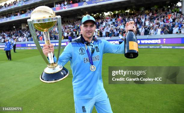 Jason Roy of England celebrates with the trophy after winning the Final of the ICC Cricket World Cup 2019 between New Zealand and England at Lord's...