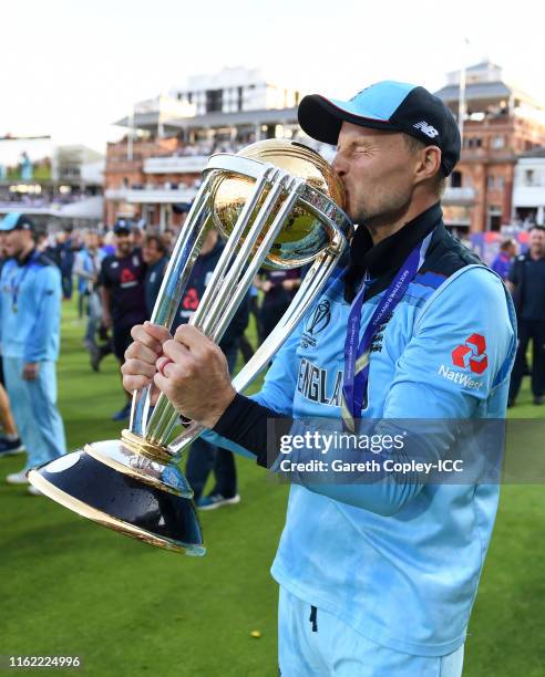 Joe Root of England celebrates with the trophy after winning the Final of the ICC Cricket World Cup 2019 between New Zealand and England at Lord's...