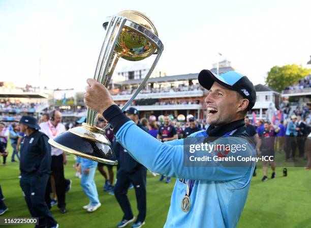 Joe Root of England celebrates with the trophy after winning the Final of the ICC Cricket World Cup 2019 between New Zealand and England at Lord's...