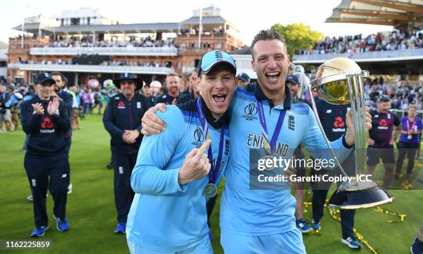 Eoin Morgan and Jos Buttler of England celebrate with the trophy after winning the Final of the ICC Cricket World Cup 2019 between New Zealand and...