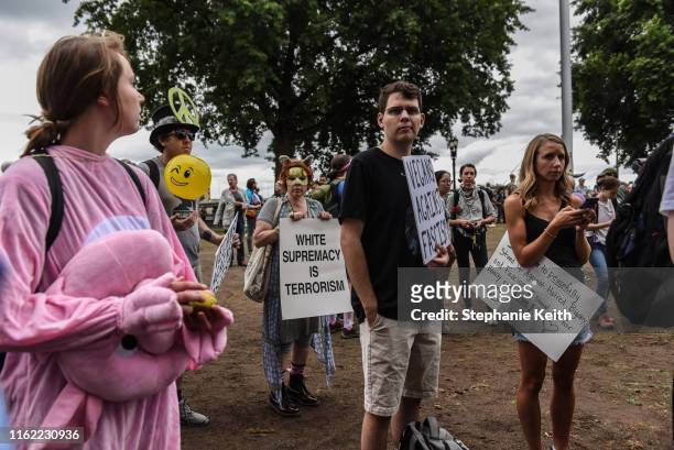 Woman holds a sign that reads "white supremacy is terrorism" during an alt-right rally on August 17, 2019 in Portland, Oregon. Anti-fascism...