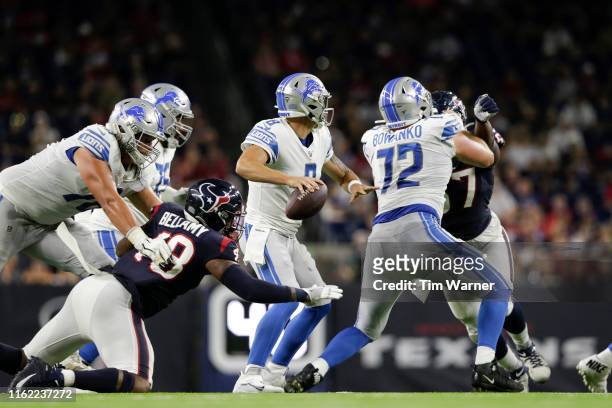 David Fales of the Detroit Lions looks to pass under pressure by Davin Bellamy of the Houston Texans in the third quarter during the preseason game...